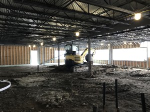 Grading is taking place in the new two story addition in the rear of the building, preparing to pour the slab.