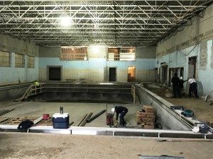 Construction in the swimming pool continues with the gutter in place, backfill complete, and gutter in place.